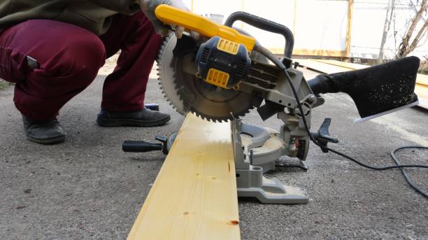 istock A worker saws a wooden board with a hand-held circular saw 2183250676