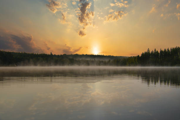 istock Lake in Sweden, mirror-smooth water with romantic light and trees on the shore 2183254898