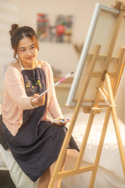 istock Woman Painting at Home Studio 2183255974