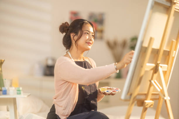 istock Woman Painting at Home Studio 2183256361