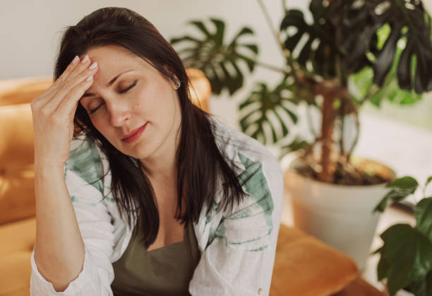 istock Woman Experiencing Stress While Sitting in a Cozy Living Room 2183256411