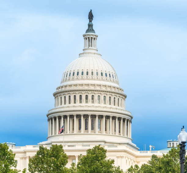 istock World famous United States Capitol dome under a blue sky with clouds 2183260827