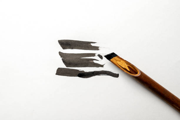 istock Calligraphy reeds covered ink on white paper 2183261113