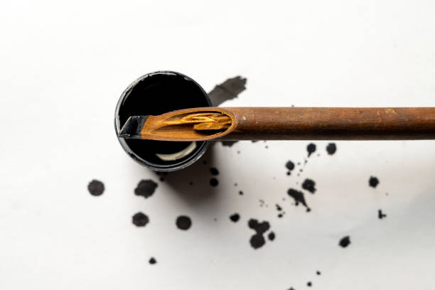 The development of the fountain pen. Set of various pens closeup on yellow paper background