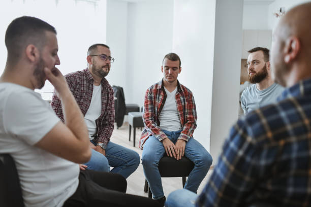 istock Adult Men Sitting in Circle in Support Group Listening and Supporting Each Other 2183262548