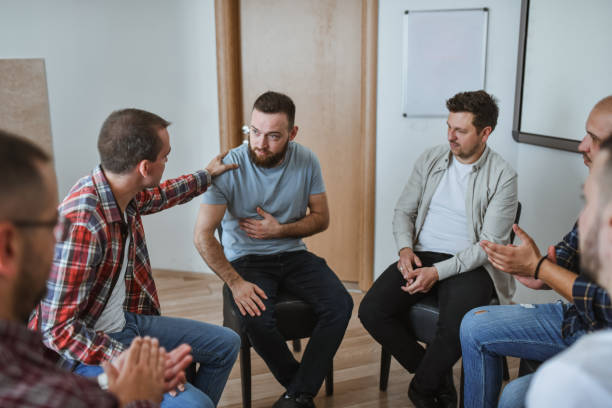 istock Adult Men Sitting in Circle in Support Group Telling Their Stories and Bonding 2183262674
