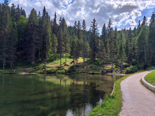 istock A serene the Lago de Ajal lake surrounded by lush trees and a winding path invites relaxation in a peaceful natural setting 2183262791