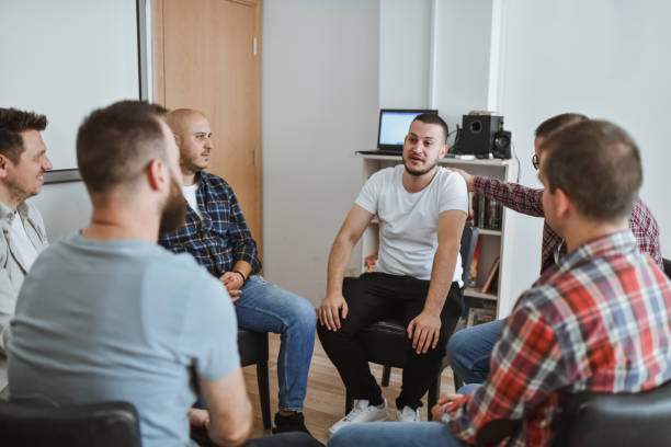 istock Handsome Male Adult Bonding With Group Therapy Members Sharing His Problems 2183263039