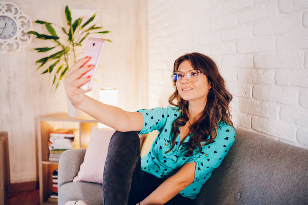istock A young woman takes a selfie at home 2183263331