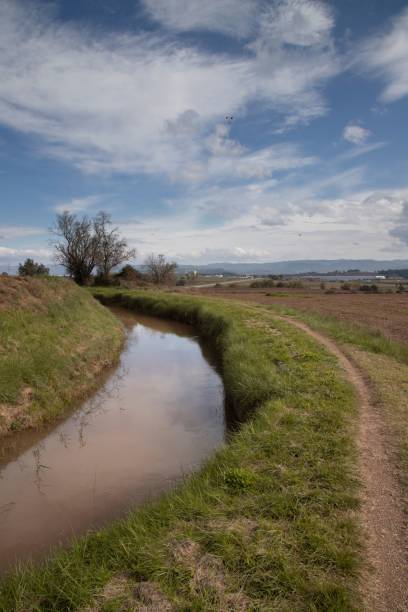 istock Serene rural landscape with a winding stream. 2183274343
