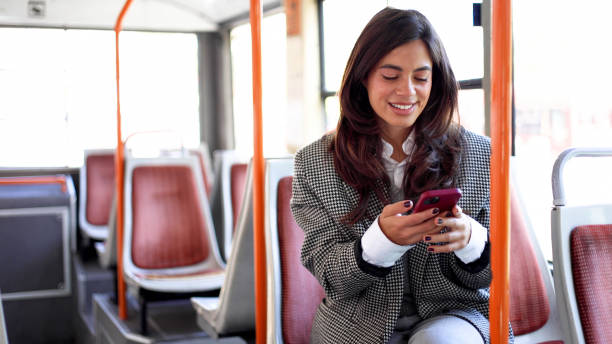istock Gorgeous woman using phone while taking a ride on a city bus 2183275888