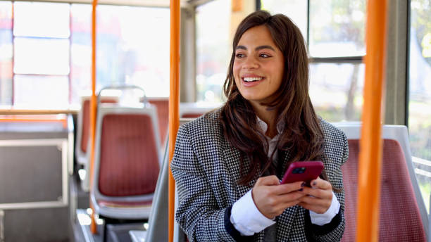 istock Gorgeous woman using phone while taking a ride on a city bus 2183275891