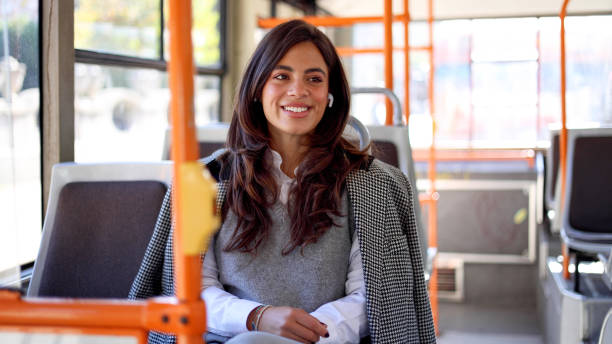 istock A young lady with a joyful expression, enjoying her journey on the bus 2183276022