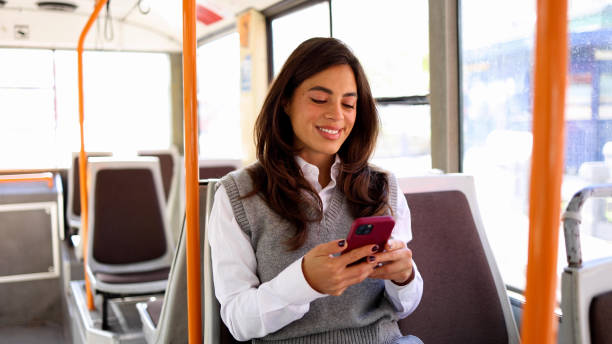 istock Woman with a bright smile using her phone during a bus ride 2183276102