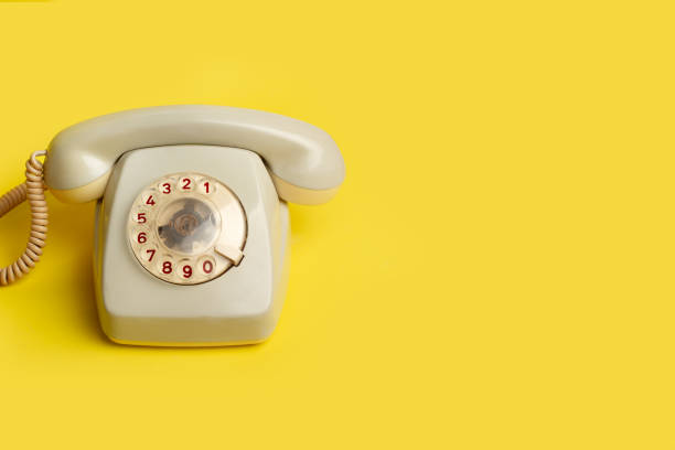 istock A vintage dial telephone on a yellow background with copy space 2183280488