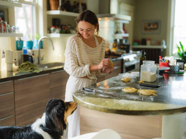 istock Woman making fresh pasta and dog is beside her 2183281663