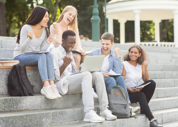 istock Group of students celebrating success, checking exam results online 2183282329