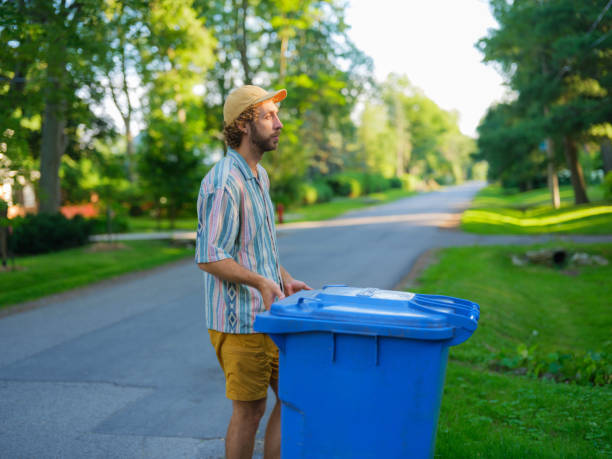 istock Man taking back his garbage bins on the front yard in suburbs 2183282363