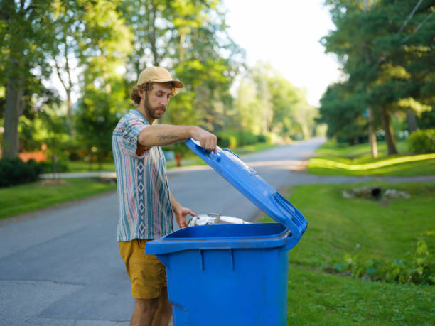 istock Man taking back his garbage bins on the front yard in suburbs 2183282511
