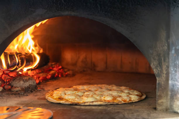 istock A delicious pizza baking in a traditional wood-fired oven, capturing the essence of authentic Italian cuisine. 2183283377