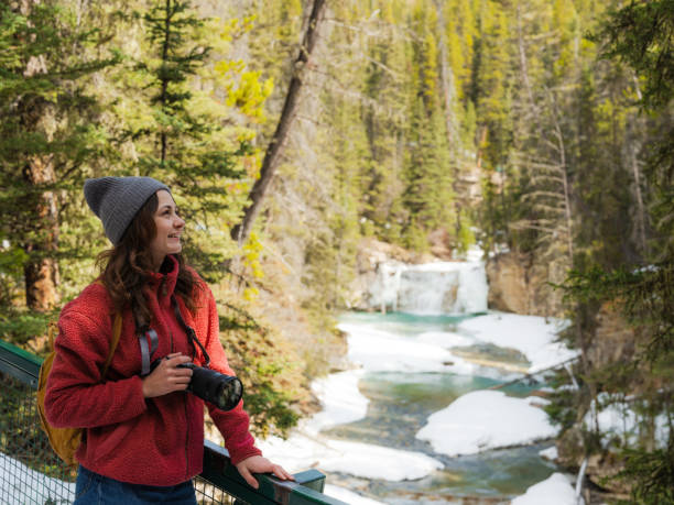 istock Woman with camera looking at Johnston canyon in springtime 2183283476