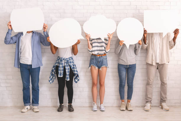 istock Group of teenagers hiding behind speech bubbles 2183283874
