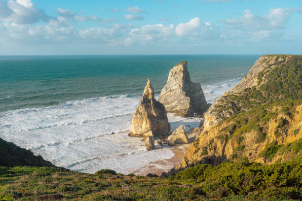 istock Dramatic Coastal Cliffs Meeting Turbulent Ocean Waves Under Blue Sky 2183284325