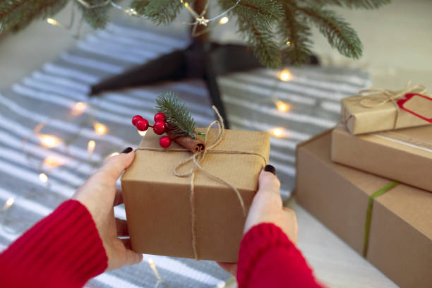 istock Woman puts presents under the Christmas tree 2183286129