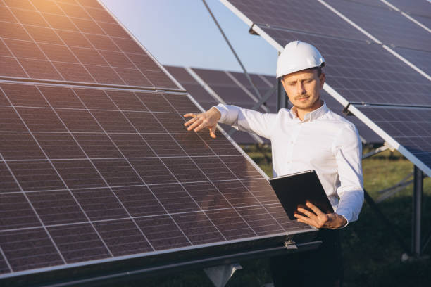 istock Engineer Inspecting Solar Panels at a Renewable Energy Farm 2183286357