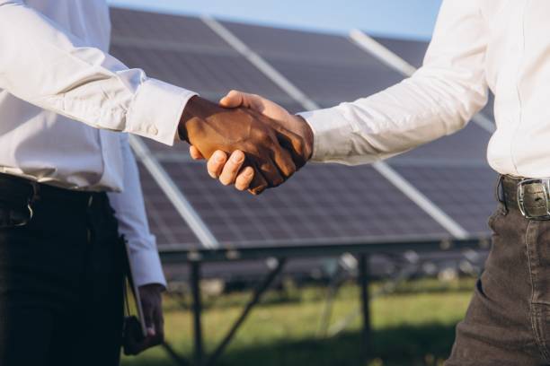 istock Two Business Professionals Shaking Hands Near Solar Panels 2183286596