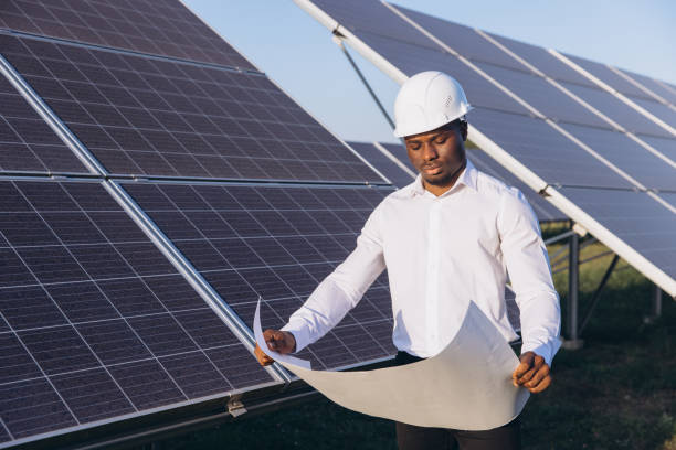 istock African American Engineer Reviewing Plans at Solar Energy Farm 2183286857