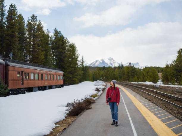 istock Woman looking at vintage train in Canada in winter 2183287048