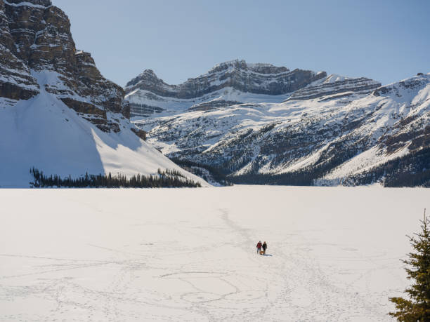 istock Two people walking on frozen lake 2183287598