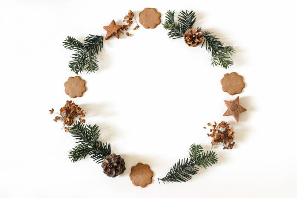 istock Christmas wreath isolated on white background. Advent circle floral composition. Christmas tree fir branches, pine cones, gingerbread cookies. Dry flowers. Winter decoration banner. Flat lay, top view. 2183288473