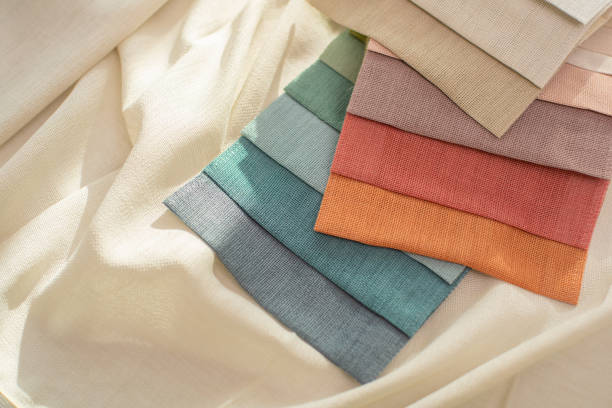 istock Samples of bright fabric for curtains. Red, orange and blue fabric for home decor on white backgroud 2183288533