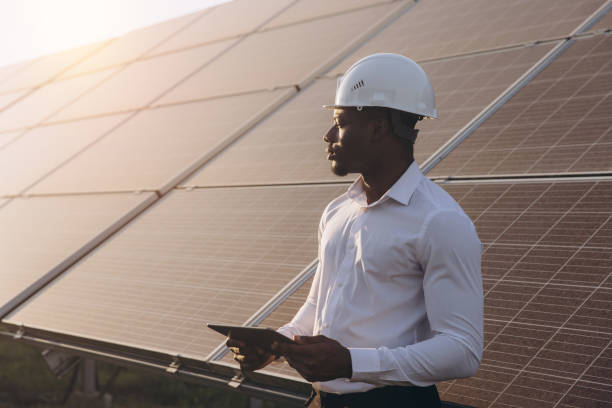 istock African American Engineer Inspecting Solar Panels with Digital Tablet Outdoors 2183289707