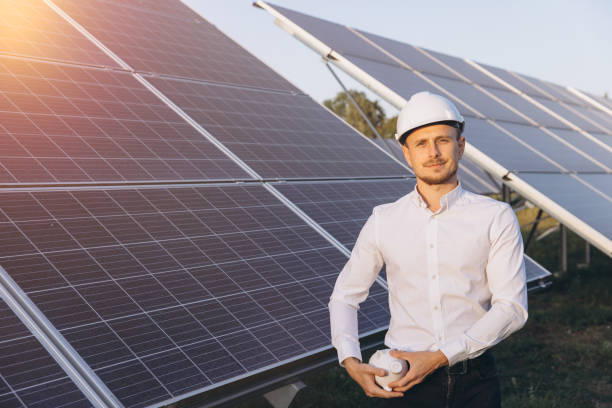 istock Engineer Inspecting Solar Panels in Renewable Energy Farm 2183289924