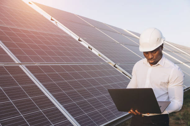istock African American Engineer Inspecting Solar Panels With Laptop in Hand 2183290212