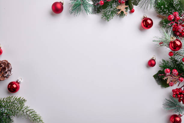 istock Colorful Christmas Decorations with Ornaments, Pine Cones, and Holly on White Background 2183290243
