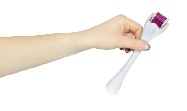 istock Mesoscooter, mesoscooter Dermaroller. Device for cosmetic mesotherapy procedures in hand, outstretched hand with mesoscooter isolated from background 2183293268