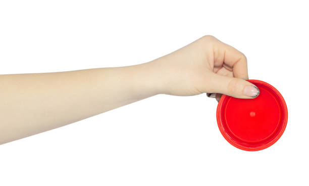 istock wide cap from a plastic bottle in hand, outstretched hand with cap from a plastic bottle isolated from background 2183293302