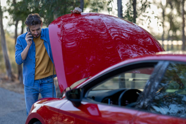 A young man on vacation tries to fix his car when it breaks down.