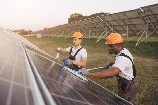 istock Workers Cleaning Solar Panels at a Solar Farm During Sunset 2183297762