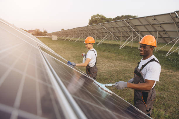 istock Team of Workers Cleaning Solar Panels on a Sunny Day 2183297771
