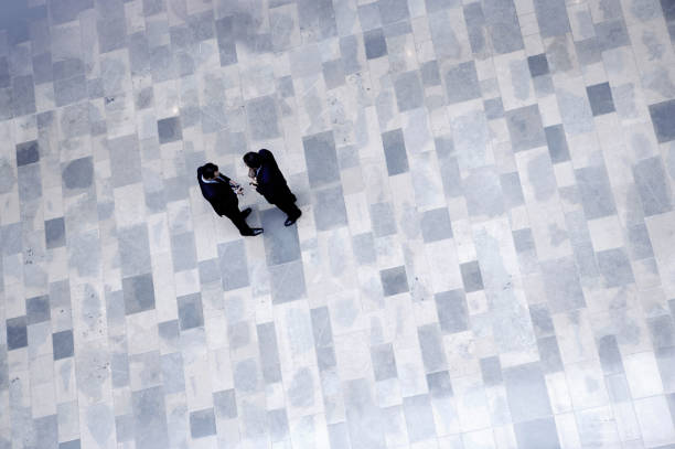 istock business men walking on stone floor. 2183298239