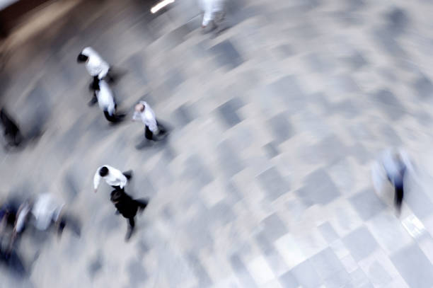 blurry background image of people walking on busy street