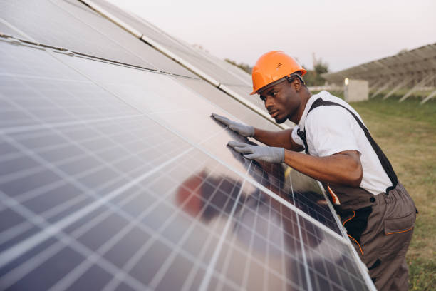 istock African American Male Engineer Inspecting Solar Panels at a Solar Farm 2183298458