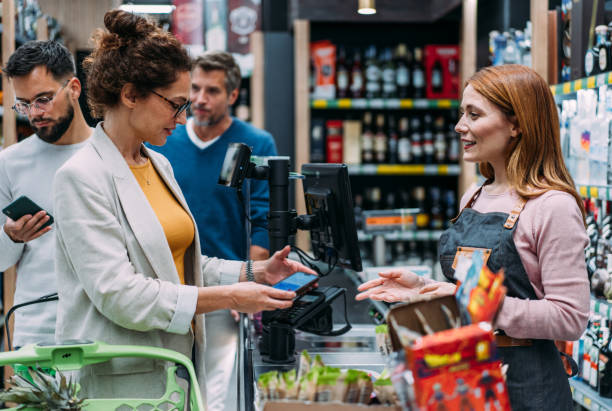 istock Woman using phone to make the payment at the supermarket 2183299743