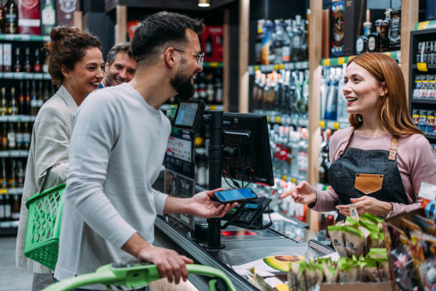 istock Man using phone to make the payment at the supermarket 2183299752