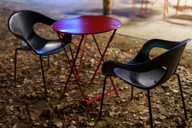 Step into a cozy cafe with fur chairs, a stylish table, a glass of water, and warm coffee, creating an inviting atmosphere for relaxation. Dark outdoors